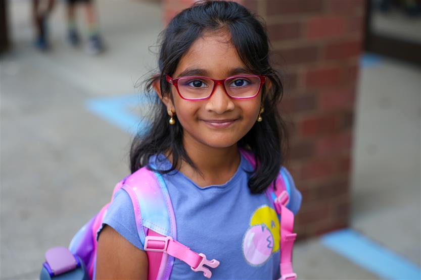 Students smile on the first day of kindergarten